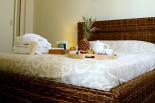 Luxury villas in Greece - Xenon Estate Althea master bedroom double rattan bed
